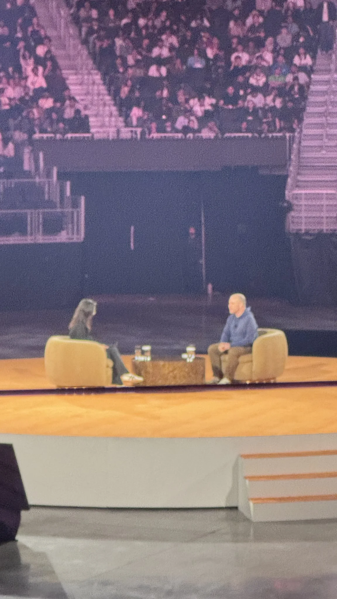 Two people talking at a conference